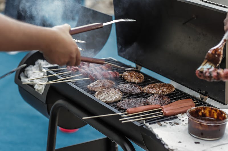 Guests lined up at a TBB buffet at an outdoor summer event